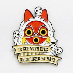 a red and white enamel pin with an image of a cat wearing goggles that says to see with eyes unglied by hate