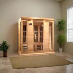 an indoor sauna is shown in the middle of a room with potted plants