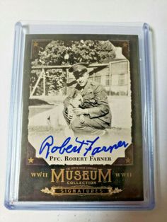 an autographed baseball card with a man sitting on the ground