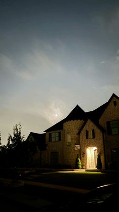 a large house lit up at night with the light on