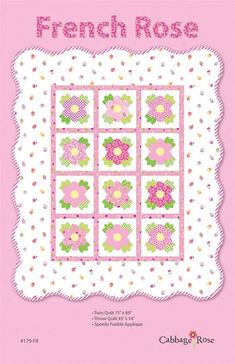 a pink and white quilt with flowers on it, in the shape of a square