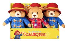 three teddy bears are in a box with paddington hats