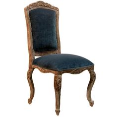 an old wooden chair with blue velvet upholstered seat and back cushion on white background