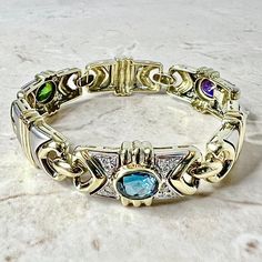 CLEARANCE 40% OFF - Vintage 1980’s 14 Karat Yellow & White Gold Blue Topaz, Green Sapphire, Amethyst & Diamond Statement Bracelet By Denoir - WeilJewelry Brazilian Jewelry, Smoky Quartz Jewelry, Gold Armband, Aquamarine Jewelry, Garnet Jewelry, Green Sapphire, Emerald Jewelry, Statement Bracelet, Jewelry Designer