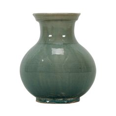 a green vase sitting on top of a white surface