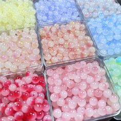 there are many different colors of beads in the trays with each one's own