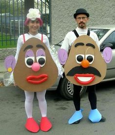 two people in costumes are standing next to a car and one is wearing a potato head