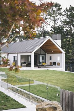 an instagram photo of a house in the middle of a field with trees and grass