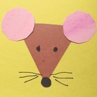 a paper mouse with pink ears on it's face