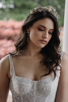 a woman in a white dress wearing a tiara