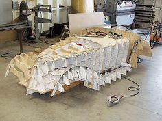 there is a table covered with papers in the middle of an assembly line at a factory