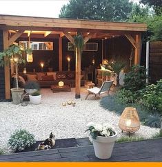 an outdoor living area with potted plants and lights