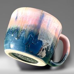 a coffee cup with an artistic design on the outside and inside, sitting on a table