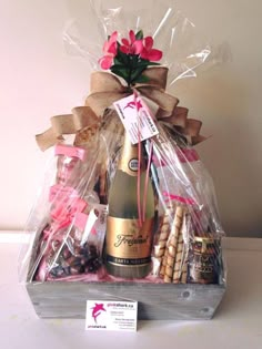 a bottle of champagne in a gift basket