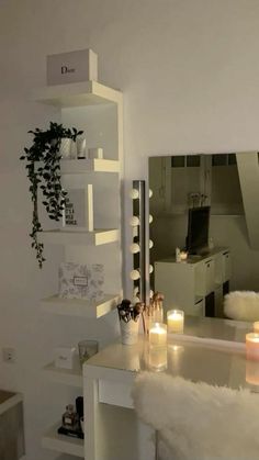 a white desk with candles on it in front of a mirror