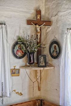 a cross and some pictures on a wall