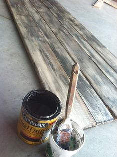 a can of paint sitting on top of a wooden bench