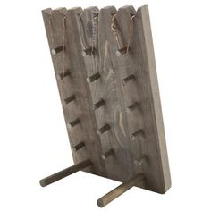 a wooden peg board with several holes in the middle and chains hanging from it's sides