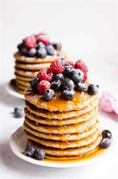 stack of pancakes with blueberries and raspberries on top