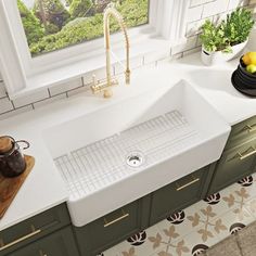 a kitchen sink sitting under a window next to a counter with fruit and vegetables on it