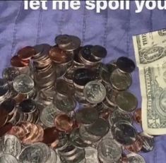 a pile of money sitting on top of a blue blanket next to a stack of coins