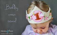 a baby girl wearing a birthday crown with the number one on it's head