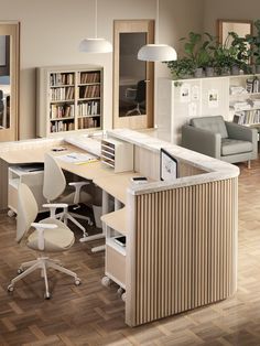 an office with two desks, chairs and a book shelf in the middle of the room