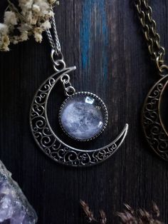 "Witchy moon necklace with your choice of silver or bronze finish, as well as your choice of length. ➳ Moon measures approximately 2\"x2\". ➳ Reference photo chart to determine the length that suits you. ➳ Bronze chain is lead free metal alloy. ➳ Silver chain is stainless steel and suitable for those with allergies to certain metals. ̩̩͙✩*̩̩͙*˚＊ ̩̩͙✩*̩̩͙*˚＊ ̩̩͙✩*̩̩͙*˚＊ ̩̩͙✩*̩̩͙*˚＊ ̩̩͙✩*̩̩͙*˚＊ ̩̩͙✩*̩̩͙*˚＊ ̩̩͙✩*̩̩͙*˚＊ 🌙 The Lunarly Lotus is a new shop but I have been a seller on Etsy for 5 years. Celestial Moon Shaped Necklace With Moon Print, Magical Silver Moon Jewelry, Magical Moon Shaped Sterling Silver Necklace, Magical Moon-shaped Sterling Silver Necklace, Moon Phase Necklace In Metal, Silver Moon-shaped Magical Necklace, Moon Phase Metal Necklace In Moon Shape, Metal Moon Phase Necklace, Magical Moon Phase Jewelry