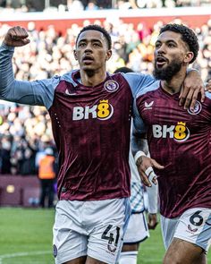 two soccer players are celebrating with their arms around each other