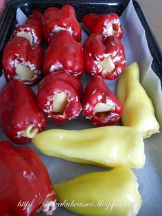 some red peppers and yellow peppers in a tray