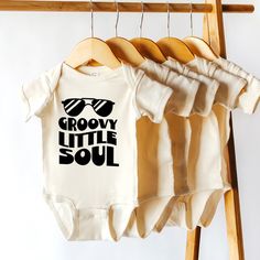 "Groovy Little Soul, Pregnancy Announcement Onesie®, Retro Kids Shirt, Kids Birthday Tee, Boho Kids Shirts, Cute Toddler Shirt, Newborn Gift HOW TO ORDER * Please review all the information provided before placing an order. 1. Select the style and size using the drop-down menu. 2. Select color 3. [APPLICABLE ONLY ON CERTAIN LISTINGS] Follow the instructions to fill out the \"Add your personalization\" option, e.g., specifying custom sayings or selecting design colors. 4. Select quantity Need mor Summer Birthday Onesie With Short Sleeves, Customizable Short Sleeve Onesie For Summer, Family Matching Onesie For Birthday In Summer, Family Matching Summer Birthday Onesie, Cotton Short Sleeve Onesie For First Birthday, Summer Family Matching Birthday Onesie, Customizable Playful Cotton Tops, Graphic Print Short Sleeve Onesie For Birthday, Customizable Short Sleeve Casual Onesie