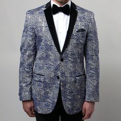 Upgrade Your Style Game With The Men's Blazer Tuxedo Jacket By Tazio! This Stunning Jacket Features A Velvet Notch Lapel And A 2 Button Closure For A Sleek And Tailored Fit. The Silver And Blue Floral Pattern Adds A Touch Of Elegance, While The 2 Front Flap Pockets Offer Functionality. Made With Dacron And Viscose, It Ensures Comfort And Durability. Perfect For Weddings, Galas, And More! Get Ready To Stand Out And Make A Statement. Royal Blue Formal Outerwear, Blue Formal Outerwear In Luxurious Style, Silver Formal Blazer For Winter, Silver Winter Formal Blazer, Silver Formal Outerwear For Winter, Formal Fitted Silver Outerwear, Classic Blue Outerwear For Party, Silver Winter Outerwear For Formal Occasions, Classic Blue Party Outerwear