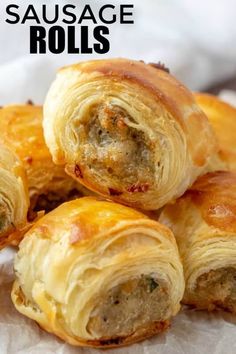 sausage rolls are piled on top of each other and ready to be eaten in the oven