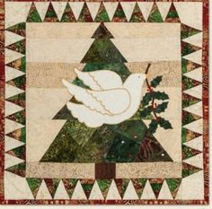 a quilted christmas tree with a dove on it's side and an ornament in the center