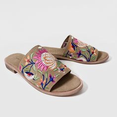 Experience luxury and style with our Rose Brown embroidered suede leather mule sandal. Made from high-quality suede leather, these mules feature intricate multicolor flower embroidery for a unique and elegant look. Slip into these mules for a comfortable and chic addition to your wardrobe. Features: Flower embroidery for floral look Cushioned footbed with suede leather covering Day to day wear Composition: Upper - 100% Leather Lining - 100% Leather Sock - 100% Leather Outsole - 100% Rubber Bohemian Spring Mules, Casual Suede Slides For Spring, Spring Suede Open Toe Slides, Summer Suede Slides, Embroidered Sandals For Spring Vacation, Spring Leather Sandals With Embroidery, Spring Embroidered Leather Sandals, Multicolor Embroidered Open Toe Sandals For Summer, Open Toe Floral Embroidery Sandals For Spring