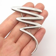 Great vintage condition.  925 Sterling Silver Vintage Zigzag Pin Brooch  Weight: 14.7g   WELCOME TO PAWN SHOP We are an actual pawn shop and have been in business for over 25 years. Since 1990, our establishment has been serving a variety of clients by providing them with short term cash solutions and options of liquidity regarding their treasured heirlooms. Acknowledging that today′s customers are very sophisticated and are looking for a variety of investments, our acquisitions are hand-picked Silver Retro Brooch Pin, Retro Silver Brooch Pin, Retro Silver Brooches For Anniversary, Silver Retro Brooches For Anniversary, Silver Retro Brooches For Gift, Pawn Shop, Pin Brooch, Hand Picked, 25 Years