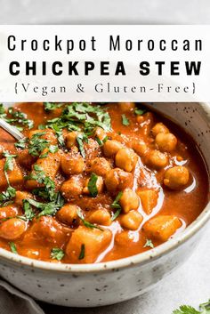 a white bowl filled with chickpea stew and garnished with cilantro