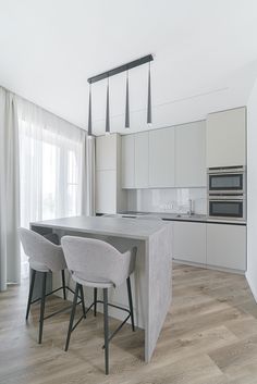 the kitchen is clean and ready to be used for cooking or dining, while also being used as a breakfast bar