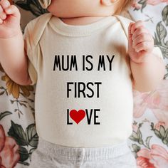 Mum is my first love onepiece romper, valentines day gift mum, pregnancy reveal one piece, baby surprise top, gift for new mum,  Color: Natural and white Packaging:  The item will be folded and individually package into resealable clear poly bags. It will then be placed inside a white polymail bag to be shipped to you. Material:  100 % cotton  Regular fit, midweight 180 gsm  preshrunk to minimise shrinkage Washing Instruction: Wash the T Shirt before wearing it. Cold, gentle wash setting with like colours only Flip the shirt inside out before washing Do not tumble dry Do not use harsh detergents or bleach Do not dry clean Warm iron, inside out This shirt is made in Australia. Please check our shop for more T shirts. Please leave us a review to help our shop grow. Cute Cotton Onesie For Mother's Day, Family Matching Cotton Onesie For Mother's Day, Cute Onesie With Letter Print For Gift, Cute Onesie With Name Print As A Gift, Family Matching Short Sleeve Onesie For Mother's Day, Mother's Day Cotton Onesie Gift, Cotton Bodysuit With Letter Print As Gift, Cotton Letter Print Bodysuit As Gift, Cute Bodysuit For Mother's Day Gift