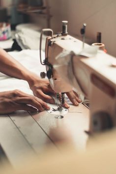 a woman is working on a sewing machine