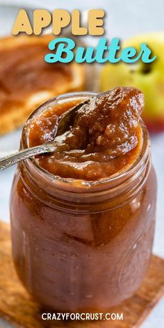 an apple butter in a jar with a spoon