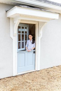 a woman standing in the doorway of a house