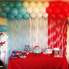 a cat in the hat themed birthday party with balloons and streamers on the wall