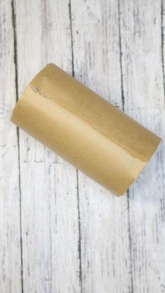 a roll of toilet paper sitting on top of a wooden table