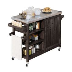 a kitchen island with stainless steel top and shelves on casteors, holds food items