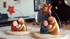 two nativity figurines sitting on top of a table