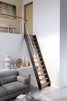 a living room filled with furniture and a stair case