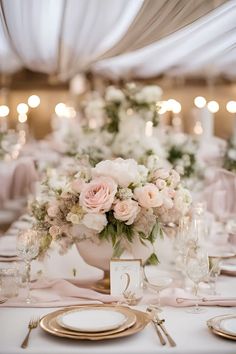 the table is set with pink and white flowers