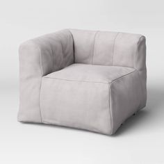 a gray chair with a square shaped cushion on the back and arms, sitting against a white background