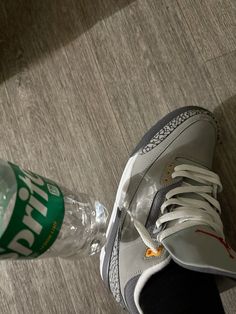 a person's shoes and water bottle on the floor